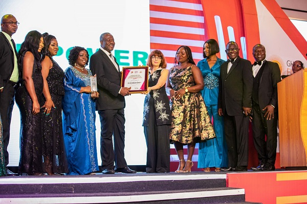 Samuel Kofi Dzamesi (middle) receiving the award