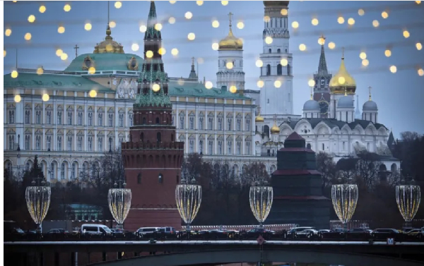 The Kremlin is seen through Christmas decorations on the bank of the Moskva river in downtown Moscow