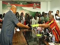 Prof Alabi (left) receives Mahama's forms at the party HQ in Accra