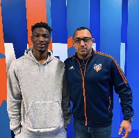 Salim with an official of his new club
