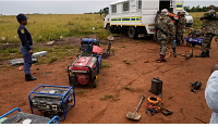 South African soldiers and police officers recovered generators and machinery left behind by miners