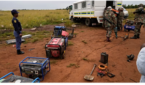 South African soldiers and police officers recovered generators and machinery left behind by miners