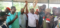 Municipal Electoral Officer(with mic) lifting the hand of Hon Robert Wisdom Cudjoe