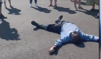 Francis Apraku lying on the floor after receiving the car