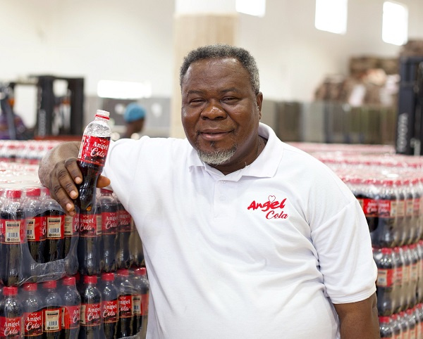 Dr. Kwaku Oteng shows off  the company's new product, Angel Cola