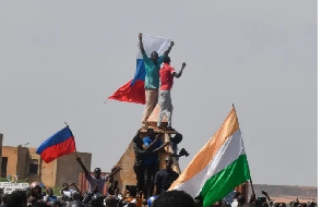 Protesters wave Nigerien and Russian flags as they gather during a rally