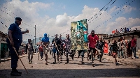 Demonstrators carrying a poster honouring DRC armed forces march during a protest in Goma