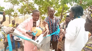 The Assemblyman together with the prophetess standing beside the newly acquired borehole