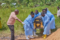 The coffin of an Ebola victim is carried to a grave in Rwampara, DRC