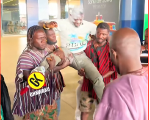 The young man was carried shoulder high after he arrived at the airport