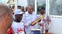 Dr. Hassan Rashid Pelpuo (holding brown envelopes) with some NDC supporters