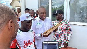 Dr. Hassan Rashid Pelpuo (holding brown envelopes) with some NDC supporters