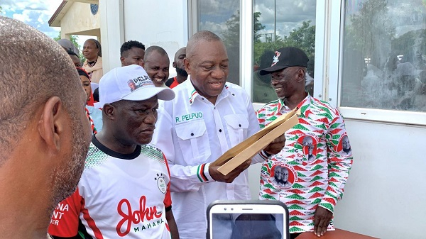 Dr. Hassan Rashid Pelpuo (holding brown envelopes) with some NDC supporters