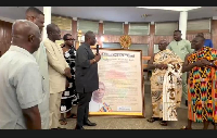 Emmanuel Armah-Kofi Buah on your left receiving the citation from the Chiefs of Western region