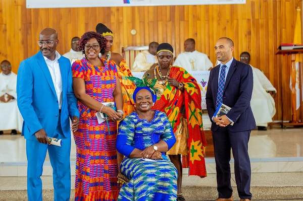 Maame Yaa Tiwaa Addo-Danquah (sitting) and surround by people