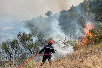 A firefighter works to extinguish a fire