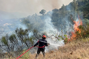 A firefighter works to extinguish a fire