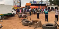 The protesters, using car tires, wooden sticks, and parked motorbikes, barricaded the road