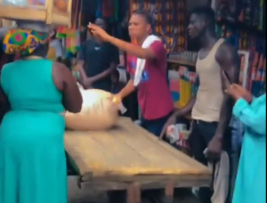 Francis Xavier Sosu assisting with the transportation of goods at Madina Market