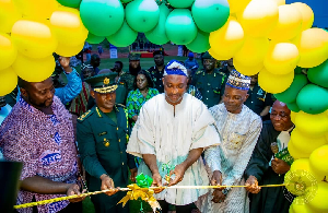 Muntaka (in white fugu) with the GIS boss to his right cutting the tape to open the facility