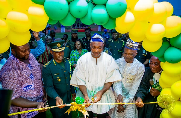 Muntaka (in white fugu) with the GIS boss to his right cutting the tape to open the facility