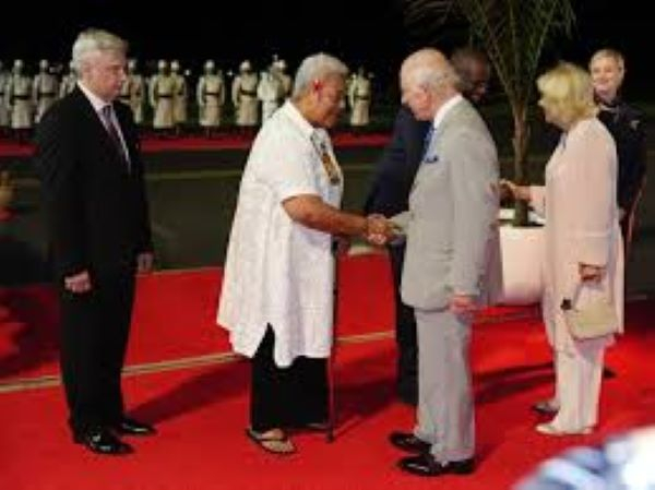Britain's King Charles III (C) shake hands with the delegates for a family photo