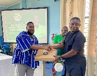 Kwame Asiemoah presenting one of the laptops to an executive in the region