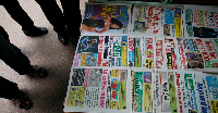 Ivorians read newspaper headlines as the country waits for election results, Abidjan, Nov 30