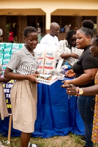 A student receiving her books as part of the project