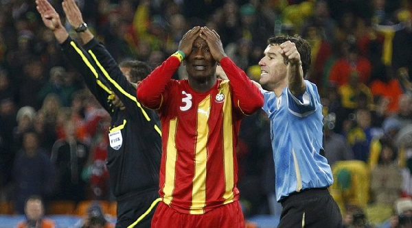 Asamoah Gyan agonizes after missing the decisive penalty kick