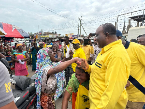 Alan Kyerematen interacting with market women during his tour