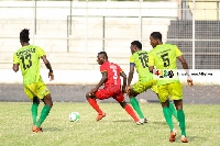 Bechem United players surround an opponent | File photo