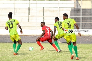 Bechem United players surround an opponent | File photo