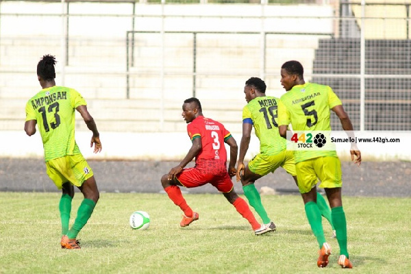 Bechem United players surround an opponent | File photo