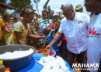 John Mahama interacting with a market woman