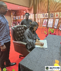 Acting Head of Mission, Jane Gasu Aheto signing the book of condolence