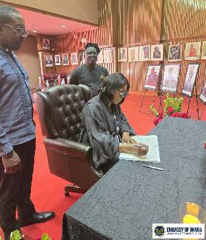 Acting Head of Mission, Jane Gasu Aheto signing the book of condolence
