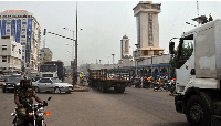 A Benin member of the military rides his motor bike near the Zogo Mosque in Cotonou, Benin, 17 Febru