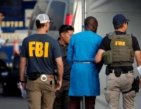 File photo of FBI operatives with a suspect