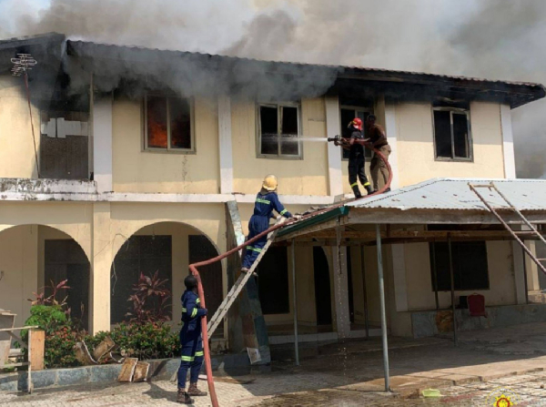 Some firefighters are seen quenching the fire at Sunshine Apartment at Suhum