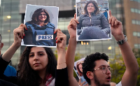 Activists hold Shireen Abu Akleh posters during a Beirut protest