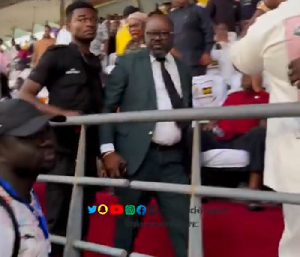 Kurt Okraku (in suit) was confronted by fans at the Accra Sports Stadium