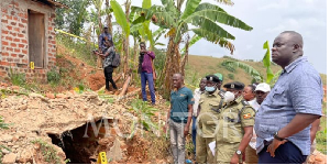 Police officers gather at the cave-like hole where four suitcases full of human skulls were discover