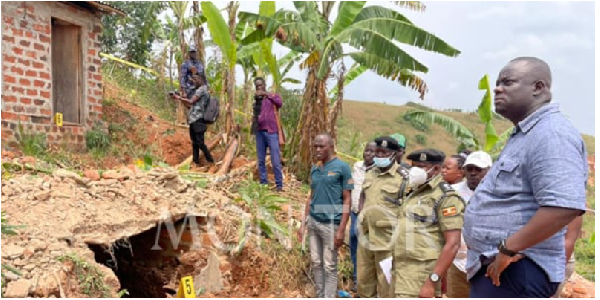 Police officers gather at the cave-like hole where four suitcases full of human skulls were discover