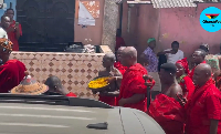 A sub-chief sprinkling 'Kpokpoi' at the festival