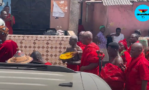 A sub-chief sprinkling 'Kpokpoi' at the festival