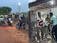 Screenshot of the man and his friends taking the machine from the shop