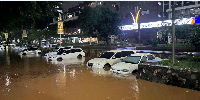 Vehicles remain partially submerged in floodwaters after heavy rainfall in Nairobi, Kenya, March 6