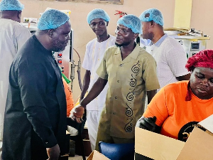 William Adzowu (L) visited several businesses in the Obuasi municipality