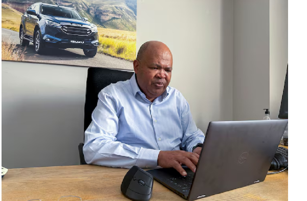 Isuzu Motors South Africa President and CEO Billy Tom works on his laptop